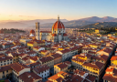Stunning panorama of Florence with the iconic red Duomo dome rising above terracotta rooftops and Tuscan hills