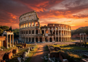 The iconic Colosseum in Rome surrounded by ancient ruins under a dramatic sunset sky